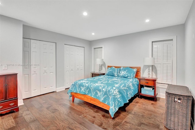 bedroom with recessed lighting, baseboards, multiple closets, and wood finished floors