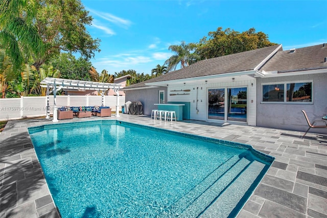 view of pool with a patio area, fence, outdoor lounge area, and a pergola