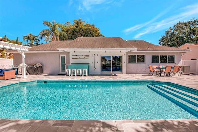 outdoor pool featuring a patio, fence, and a pergola