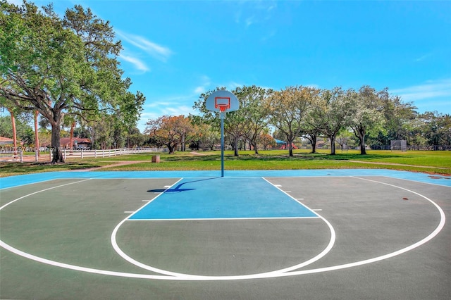 view of sport court featuring community basketball court, a yard, and fence