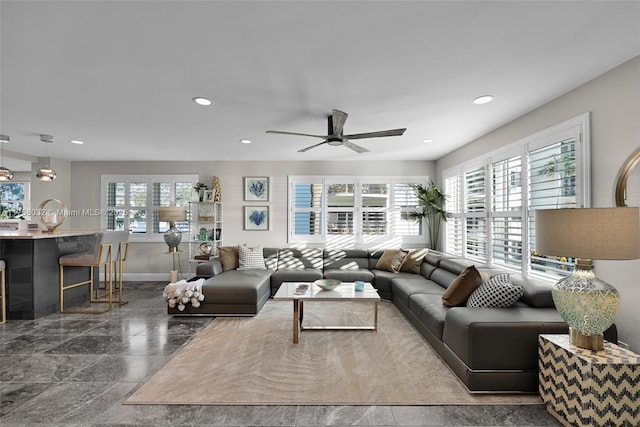 living area featuring a ceiling fan, recessed lighting, baseboards, and a wealth of natural light