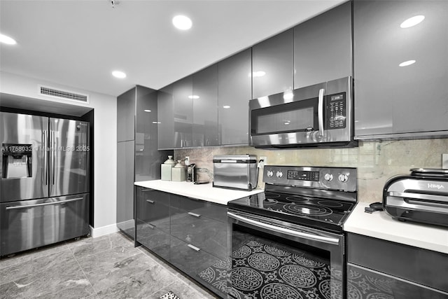 kitchen featuring visible vents, tasteful backsplash, recessed lighting, appliances with stainless steel finishes, and light countertops