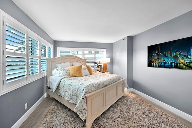 bedroom featuring baseboards and light wood-style floors