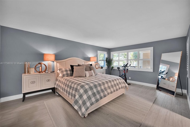 bedroom featuring baseboards and wood finished floors