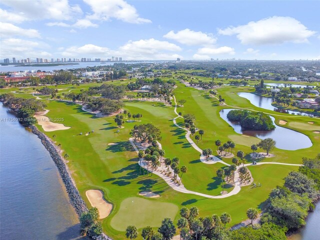 birds eye view of property featuring a city view, golf course view, and a water view