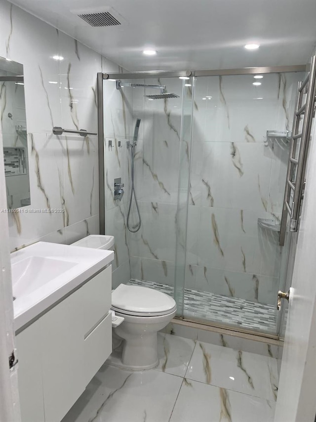 bathroom with a marble finish shower, visible vents, toilet, and vanity