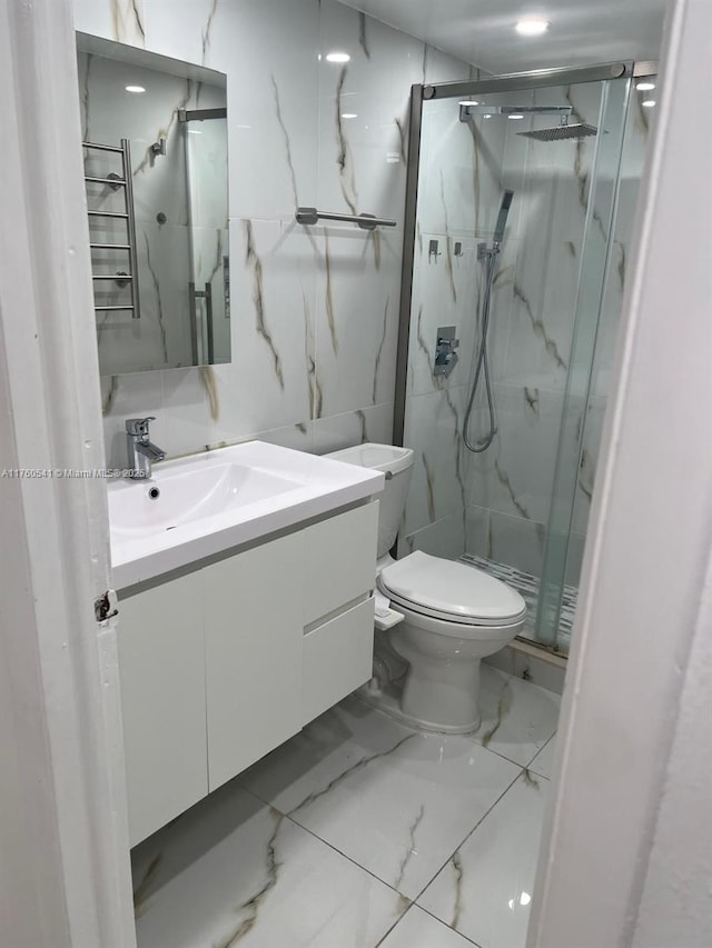 full bathroom with a marble finish shower, marble finish floor, toilet, and vanity