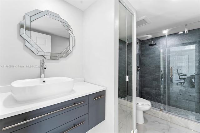 bathroom with vanity, marble finish floor, a shower stall, and toilet