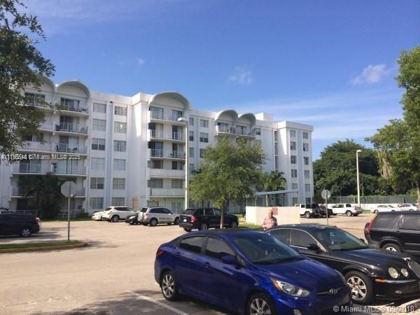 view of building exterior with uncovered parking