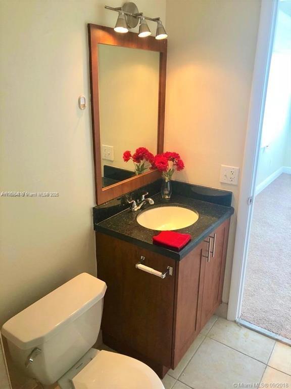 bathroom with tile patterned floors, toilet, and vanity