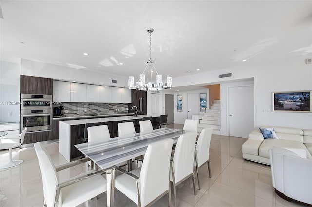 dining room featuring visible vents, a chandelier, stairs, light tile patterned floors, and recessed lighting