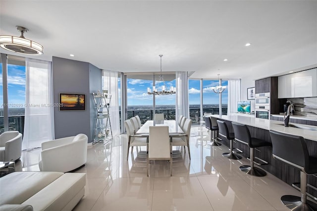 dining space featuring a wall of windows, a notable chandelier, and recessed lighting