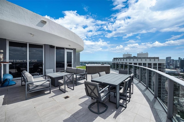 view of patio with a view of city, a balcony, and central air condition unit