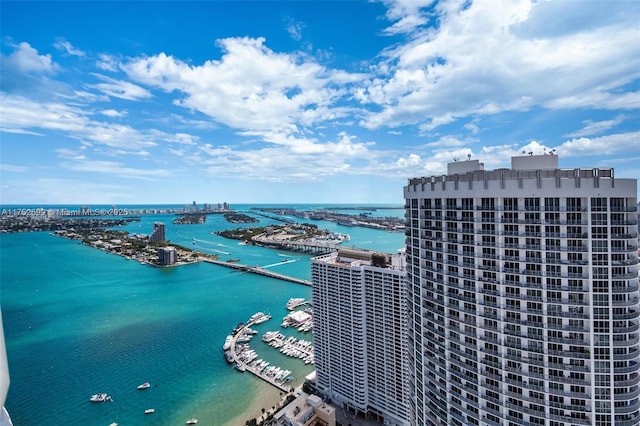 birds eye view of property with a view of city and a water view