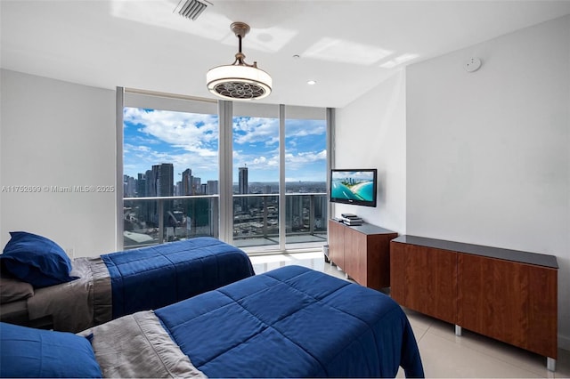 bedroom featuring a wall of windows, access to exterior, light tile patterned floors, and visible vents