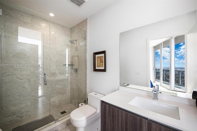 full bathroom featuring visible vents, vanity, toilet, and a shower stall