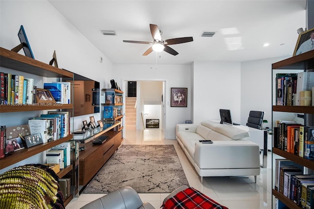 tiled living room featuring a ceiling fan and visible vents