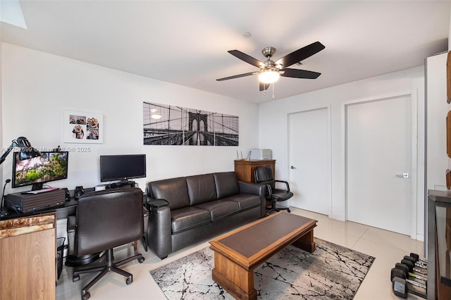 home office with a ceiling fan and tile patterned flooring