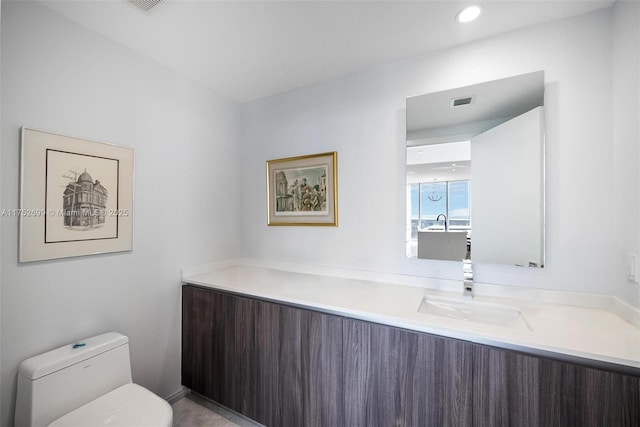 bathroom with recessed lighting, visible vents, toilet, and vanity