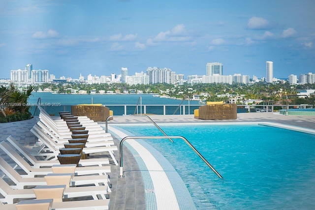 view of pool with a view of city