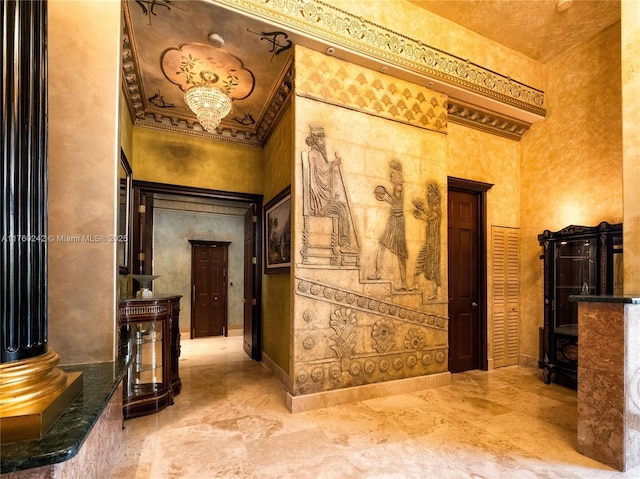 hallway featuring baseboards, a towering ceiling, and crown molding