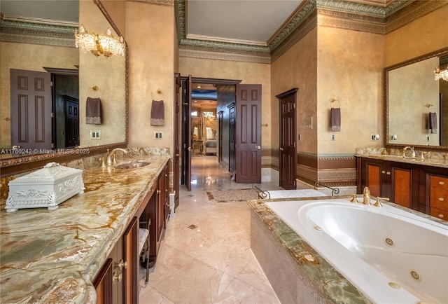 full bath featuring vanity, a high ceiling, crown molding, a jetted tub, and marble finish floor