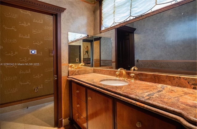 bathroom featuring vanity, tile patterned floors, and baseboards