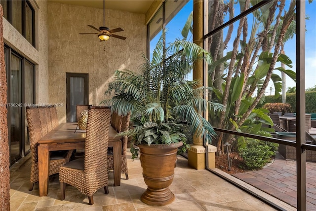 sunroom / solarium featuring a ceiling fan and a wealth of natural light