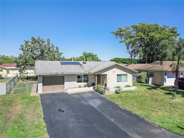 single story home with a front yard, a gate, driveway, solar panels, and a garage