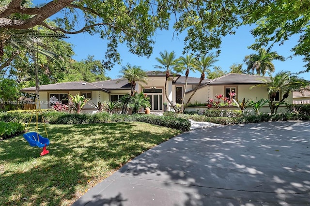 view of front of home featuring stucco siding and a front yard