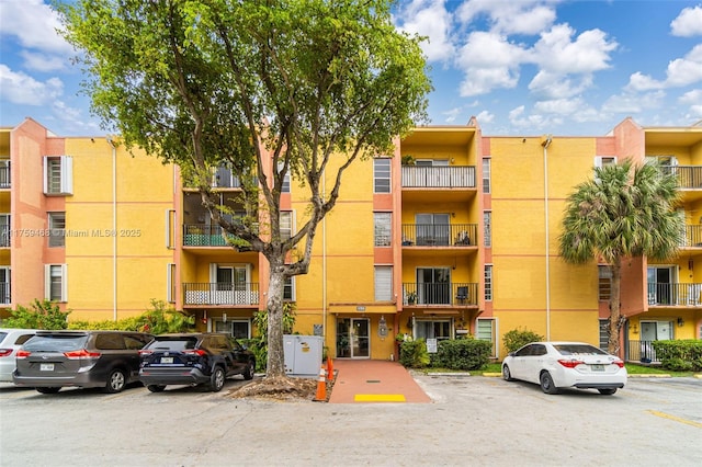 view of building exterior featuring uncovered parking