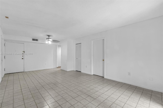 unfurnished room with visible vents, baseboards, and a ceiling fan