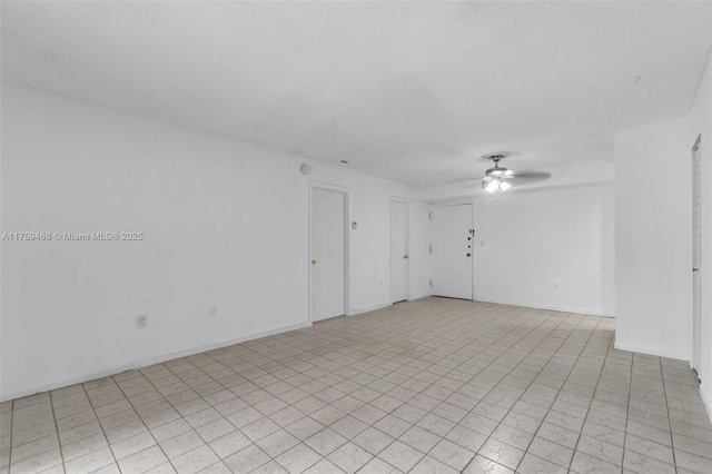 spare room featuring baseboards and a ceiling fan