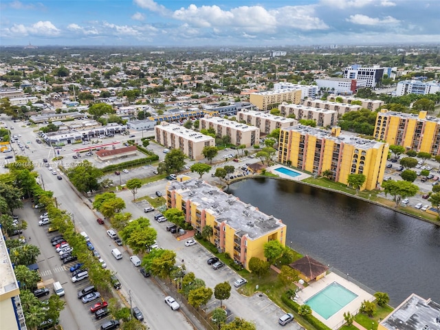 drone / aerial view featuring a city view and a water view