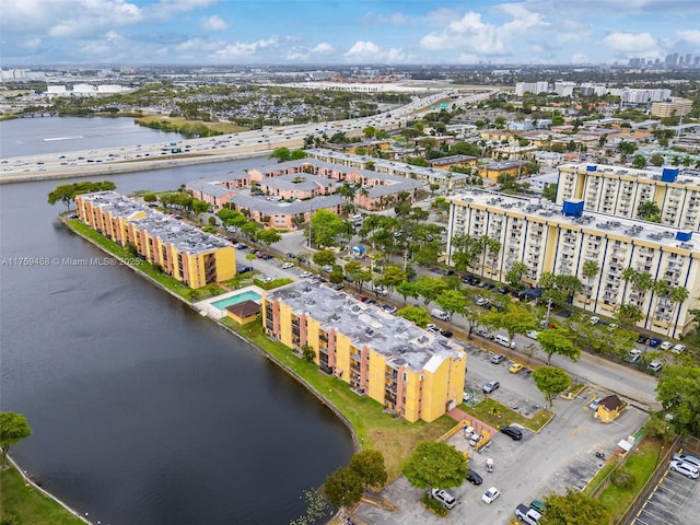 drone / aerial view featuring a city view and a water view