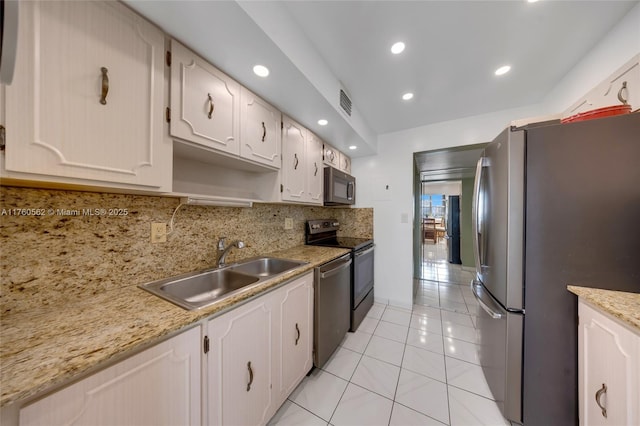 3113 S Ocean Dr Unit 506, Hallandale Beach, FL 33009 - kitchen featuring visible vents, a sink, backsplash, appliances with stainless steel finishes, and light tile patterned floors