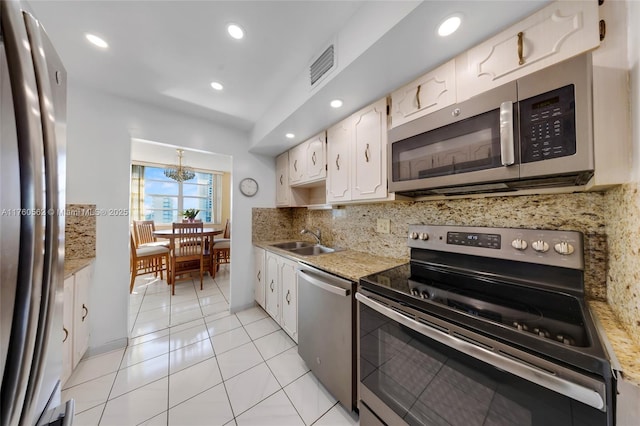 3113 S Ocean Dr Unit 506, Hallandale Beach, FL 33009 - kitchen with visible vents, decorative backsplash, white cabinets, stainless steel appliances, and a sink