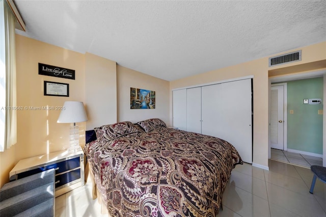 3113 S Ocean Dr Unit 506, Hallandale Beach, FL 33009 - tiled bedroom featuring visible vents, baseboards, a textured ceiling, and a closet