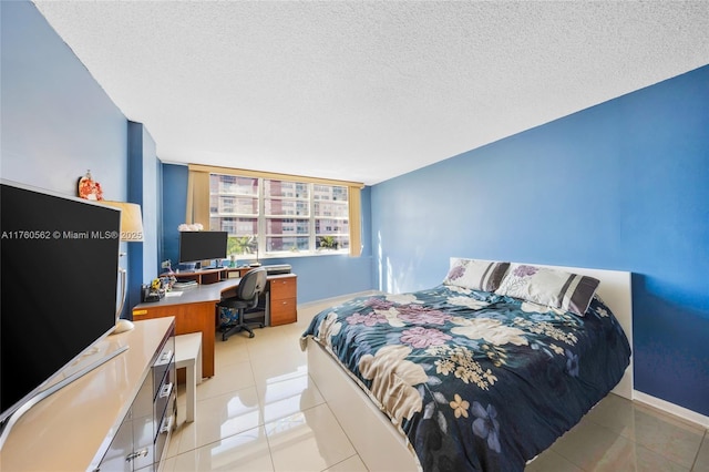 3113 S Ocean Dr Unit 506, Hallandale Beach, FL 33009 - bedroom with light tile patterned floors, a textured ceiling, and baseboards