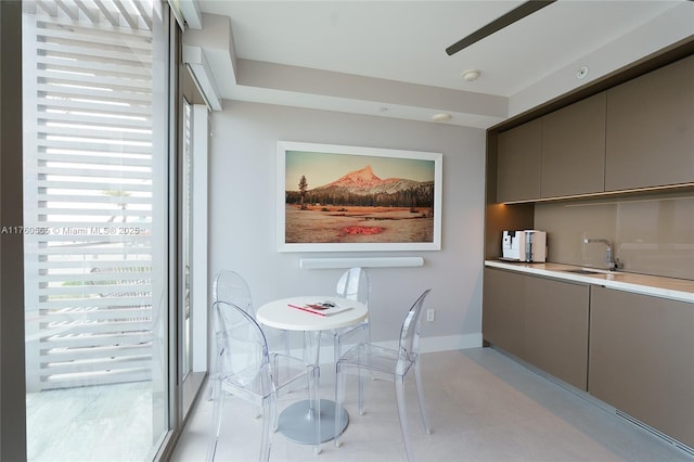 dining area with light tile patterned floors and baseboards