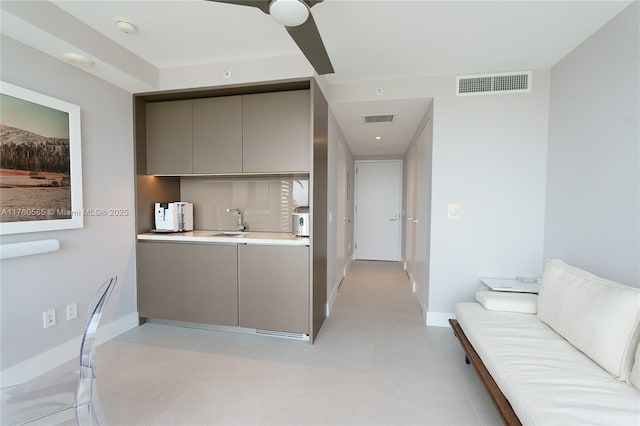 kitchen featuring visible vents, gray cabinets, modern cabinets, and a sink