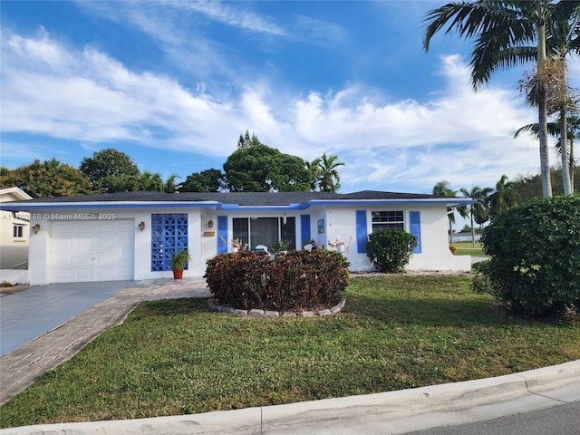 ranch-style house featuring stucco siding, a garage, concrete driveway, and a front yard