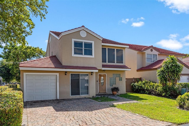 view of front facade with a tile roof, a front lawn, a garage, and stucco siding