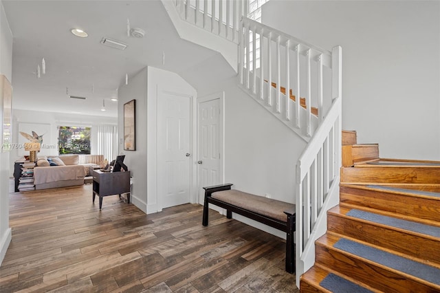 stairs with recessed lighting, baseboards, and wood finished floors