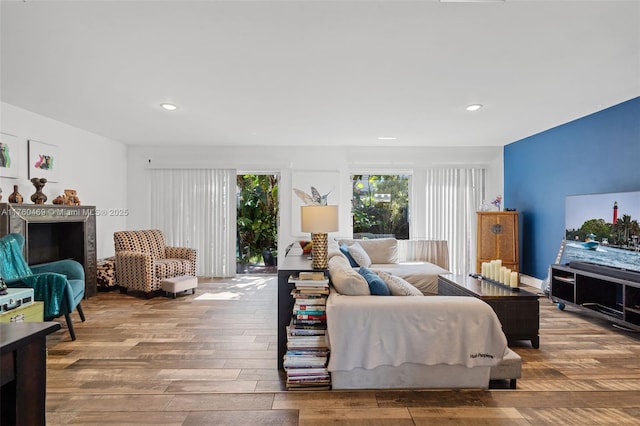 living area with recessed lighting and wood finished floors