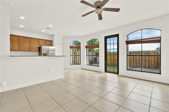 interior space featuring light tile patterned floors, recessed lighting, and a healthy amount of sunlight