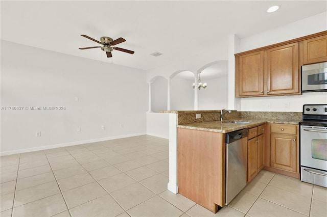 kitchen with visible vents, a sink, stone countertops, appliances with stainless steel finishes, and light tile patterned flooring