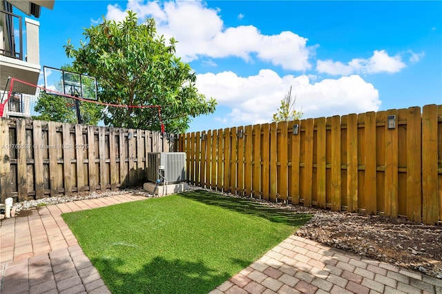 view of yard featuring central AC unit and a fenced backyard