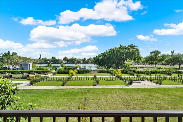 view of community with a yard and a water view