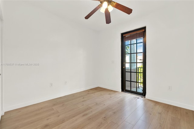 empty room with baseboards, light wood finished floors, and ceiling fan